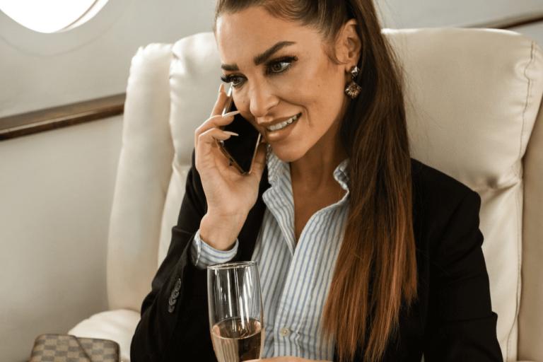 A women is talking on phone while riding a private jet
