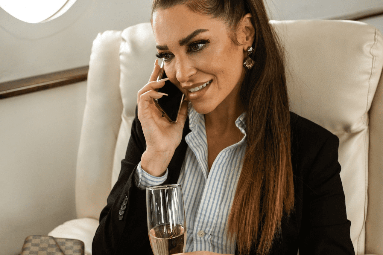 A women is talking on phone while riding a private jet